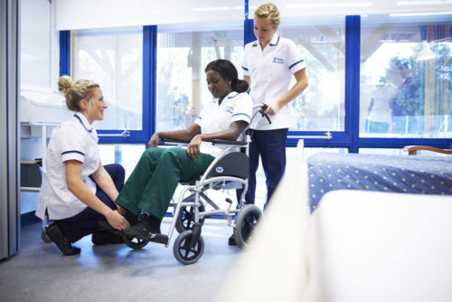 Students learning together to use a wheelchair